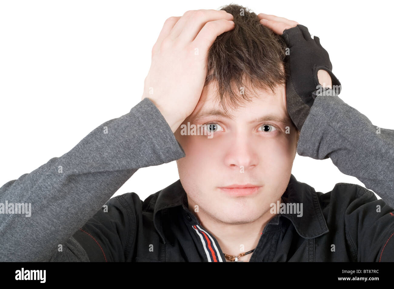 The young man pressure a head. Isolated Stock Photo