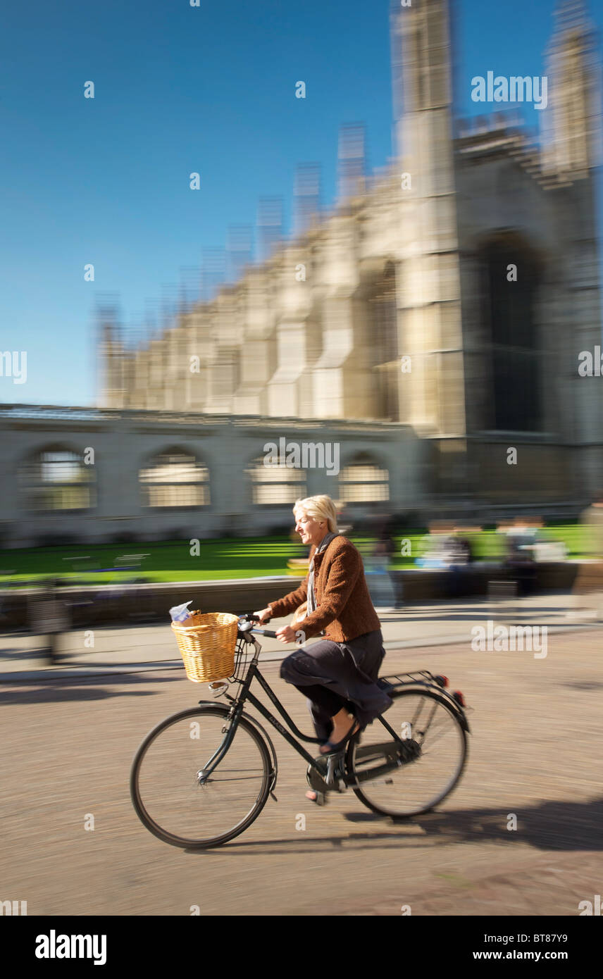Cycling past King's College, Cambridge Stock Photo