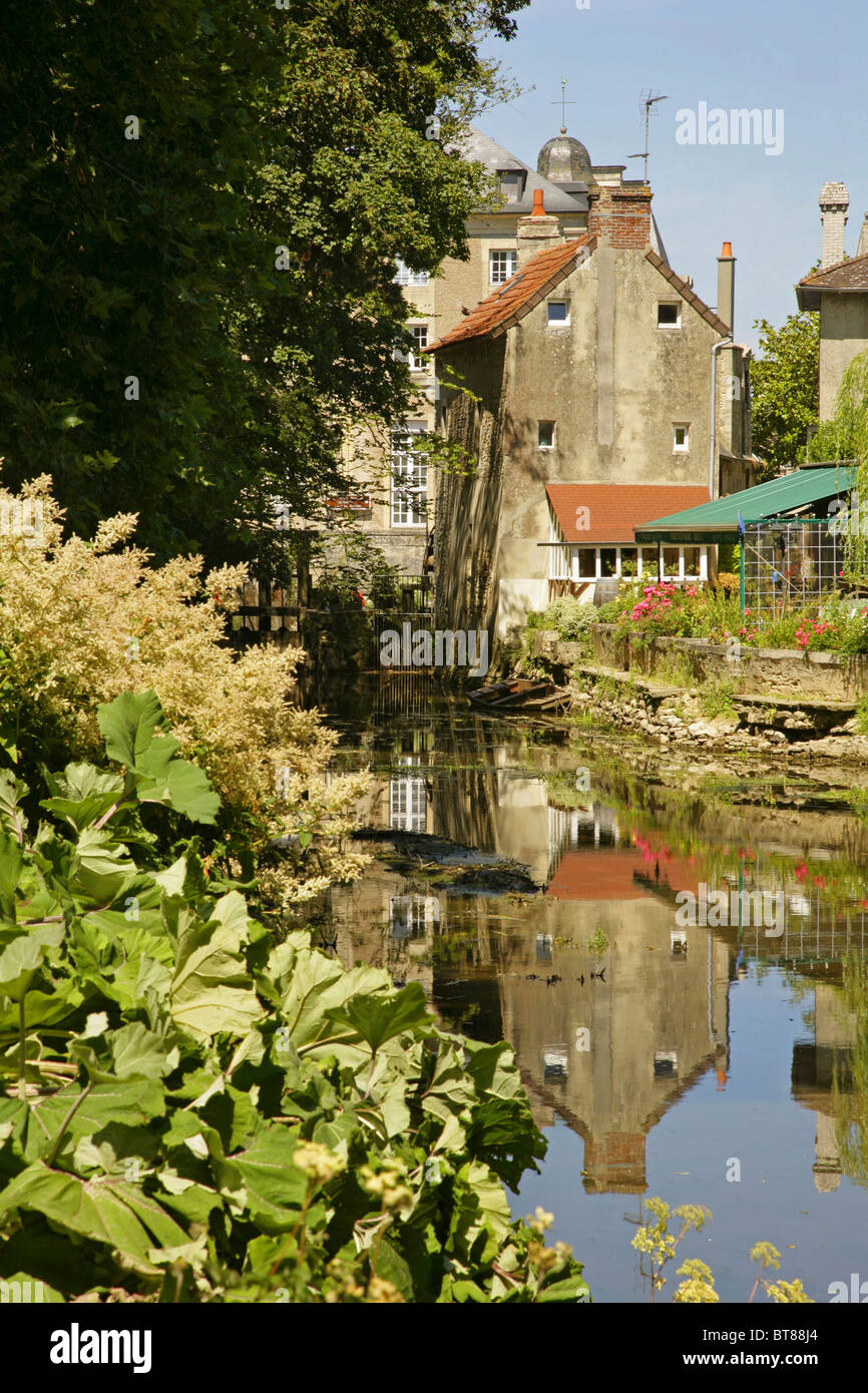 Old stone buildings alongside the River Aure, Bayeux, Normandy, France. Stock Photo