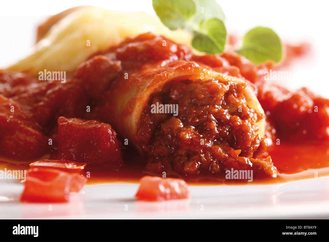 Canneloni with minced meat and tomato sauce Stock Photo