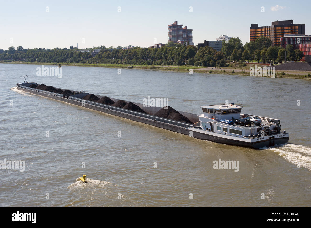 Pulverised coal being transported by barge on the river Rhine, Germany