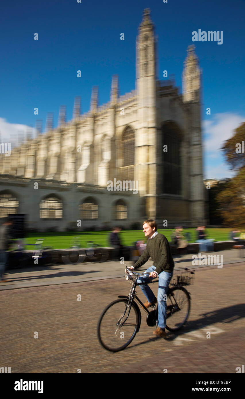 Student cycling past King's College, Cambridge University Stock Photo