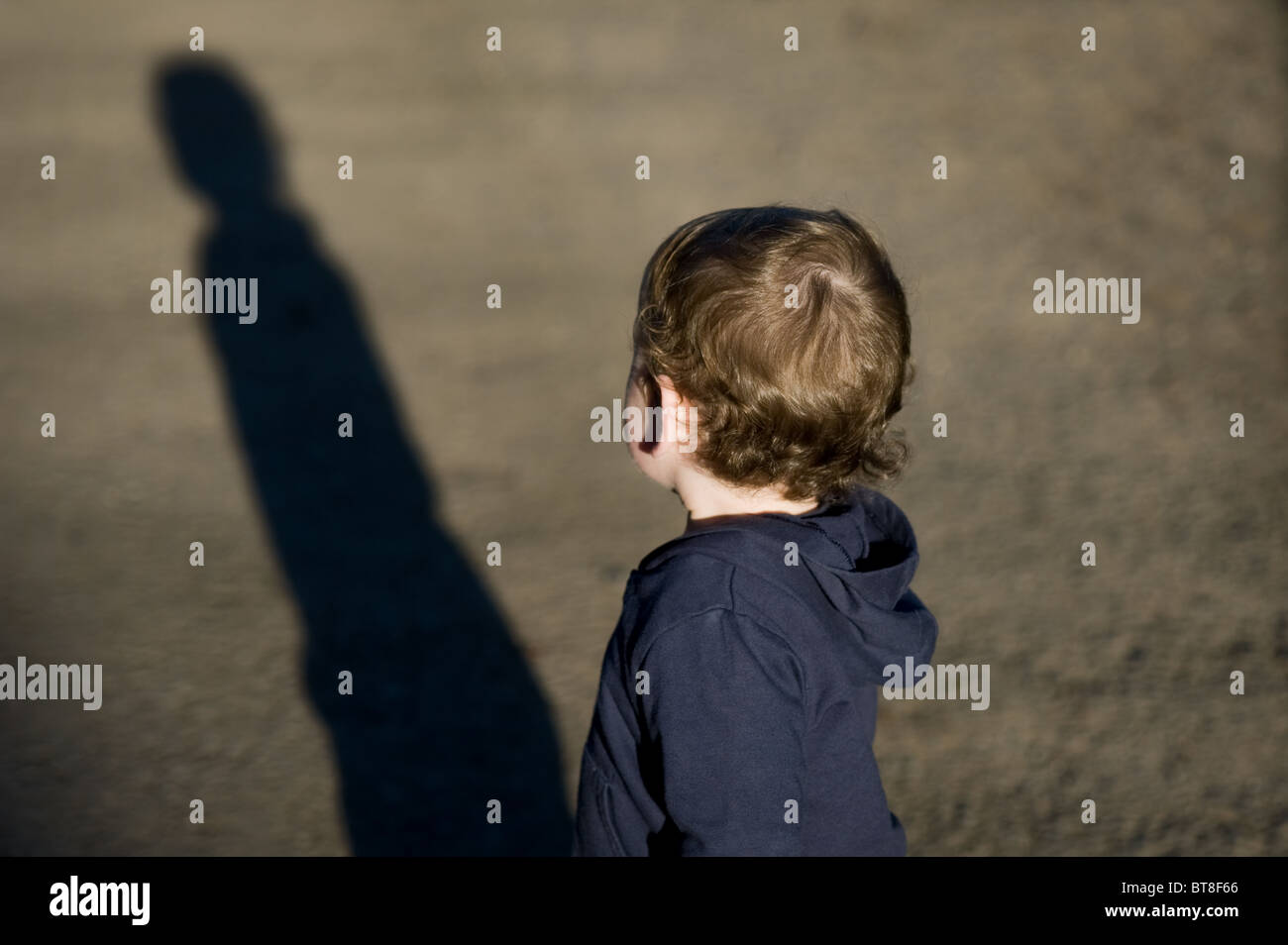 Child cast a long shadow Stock Photo