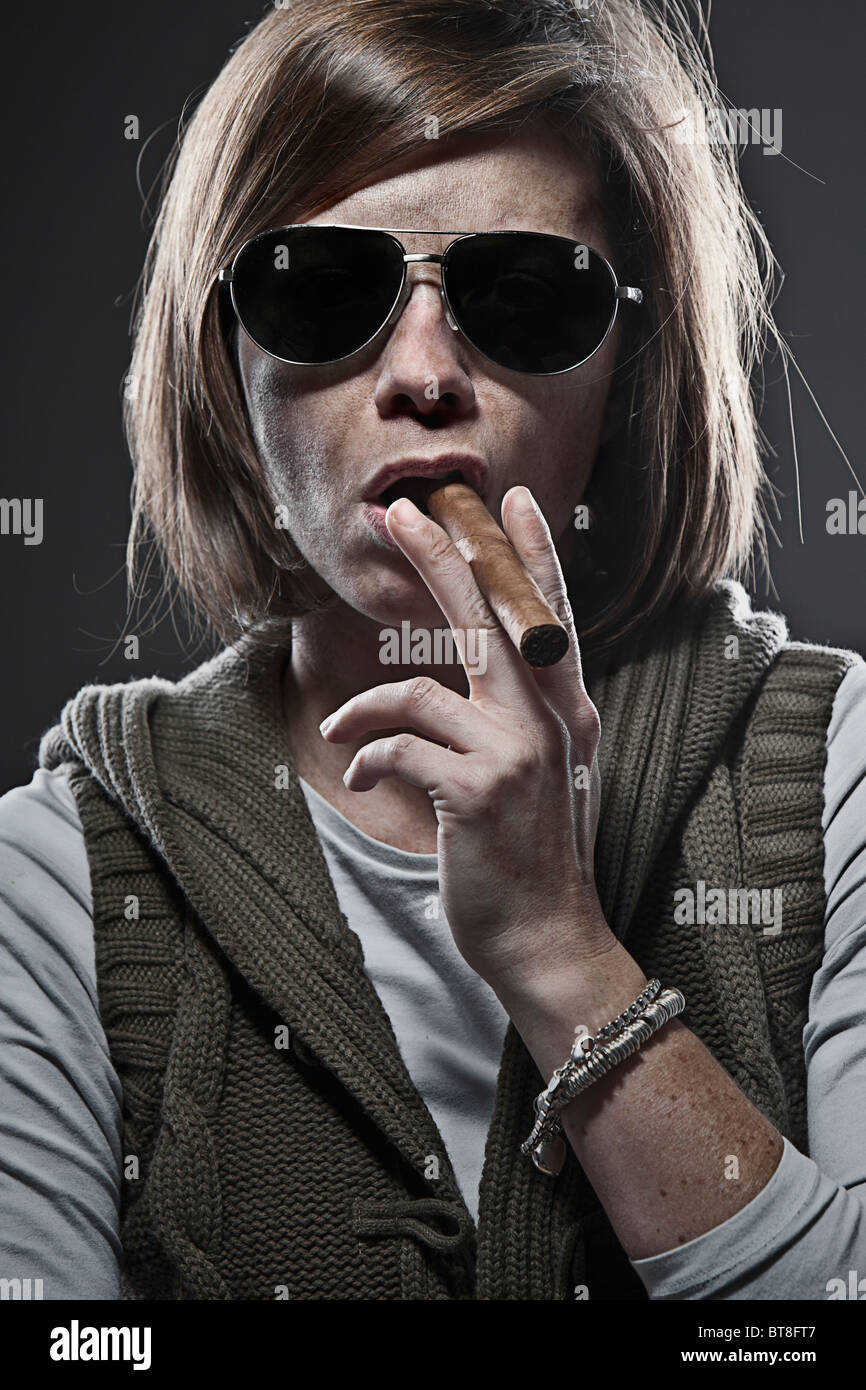 Shot of a Woman Smoking a Cigar Stock Photo