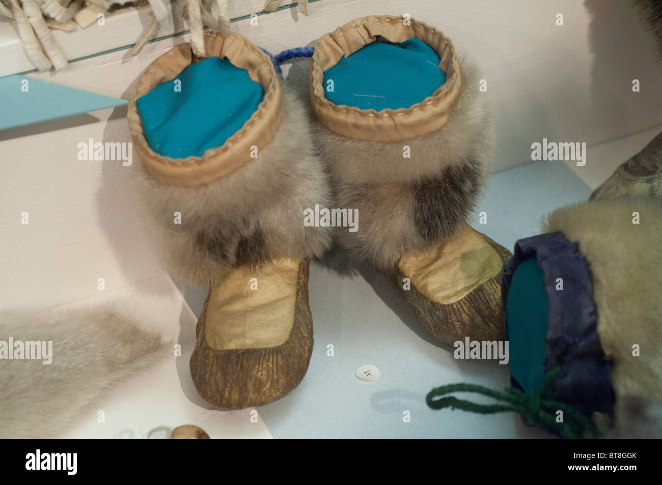 Arctic Canada, Nunavut, Baffin Island, Iqaluit (aka Frobisher Bay). Nunatta Sunakkutaangit Museum. Eskimo fur boots. Stock Photo