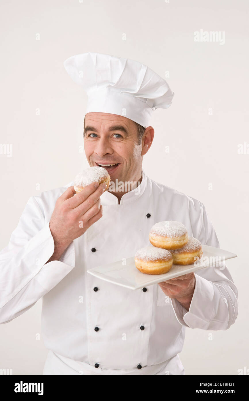 Confectioner trying his pastries Stock Photo