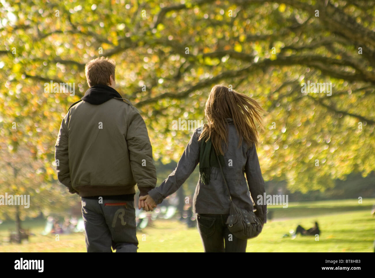 boy and girl, young couple walking in park in autumn Stock Photo - Alamy