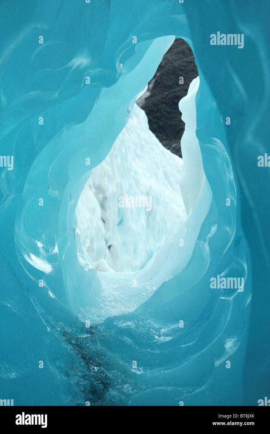 View of rock through a hole in glacier cave Stock Photo