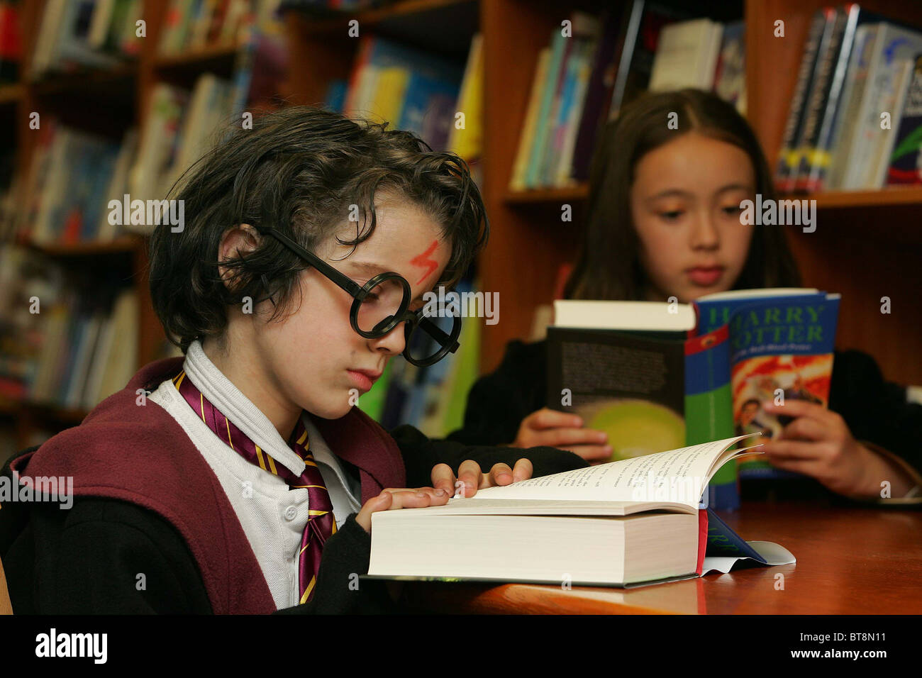 Children read 'Harry Potter and the half blood prince'  Picture by James Boardman Stock Photo