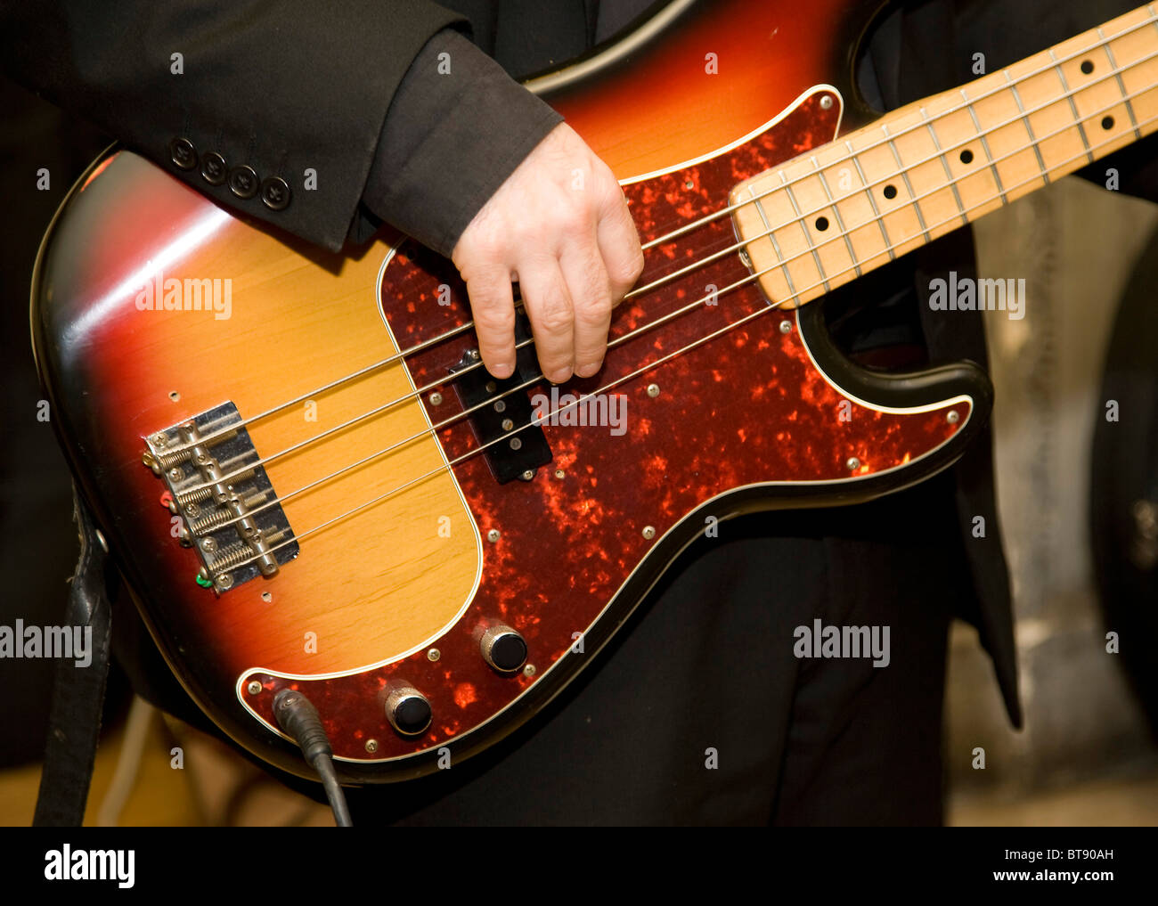 Bass Guitar being played in a band Stock Photo
