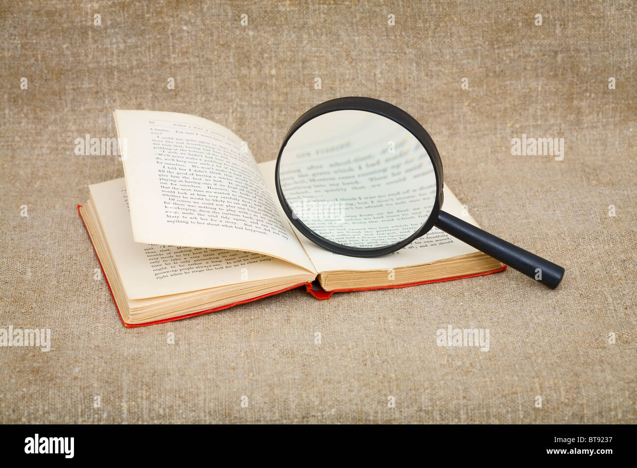 Still-life from a magnifier and the old book Stock Photo