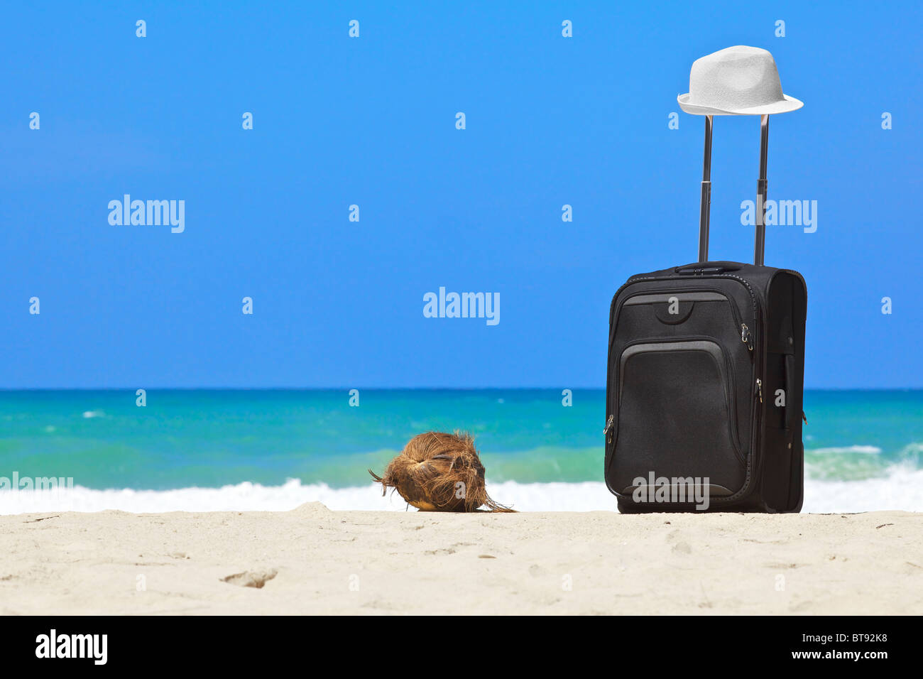 Suitcase on the tropical beach Stock Photo