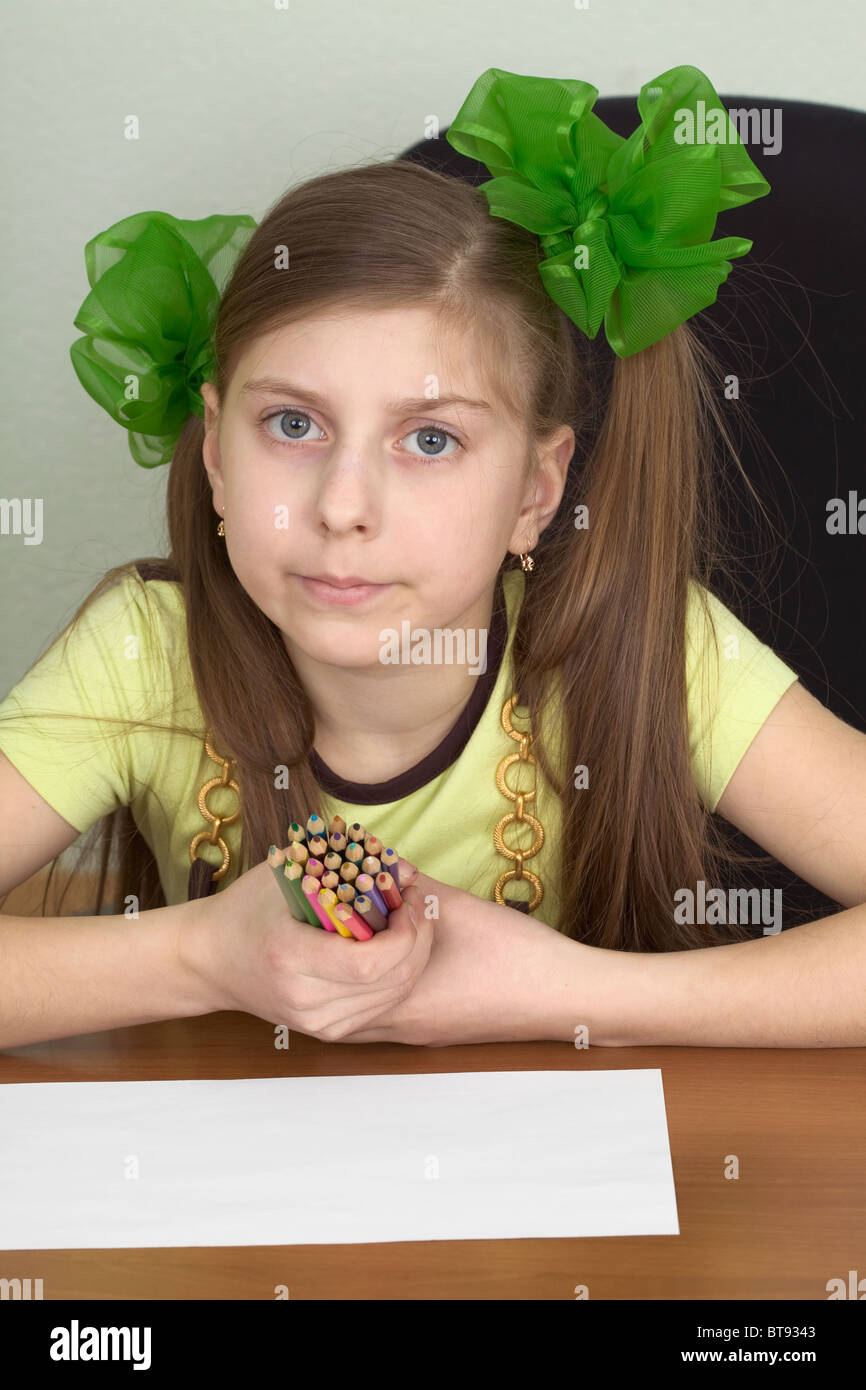Girl with color pencils in hands and a sheet of paper Stock Photo - Alamy