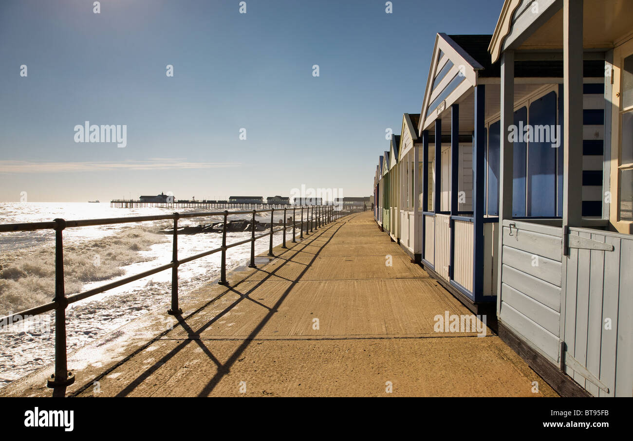 Beach huts on Southwold Promenade with the Pier in background Stock Photo