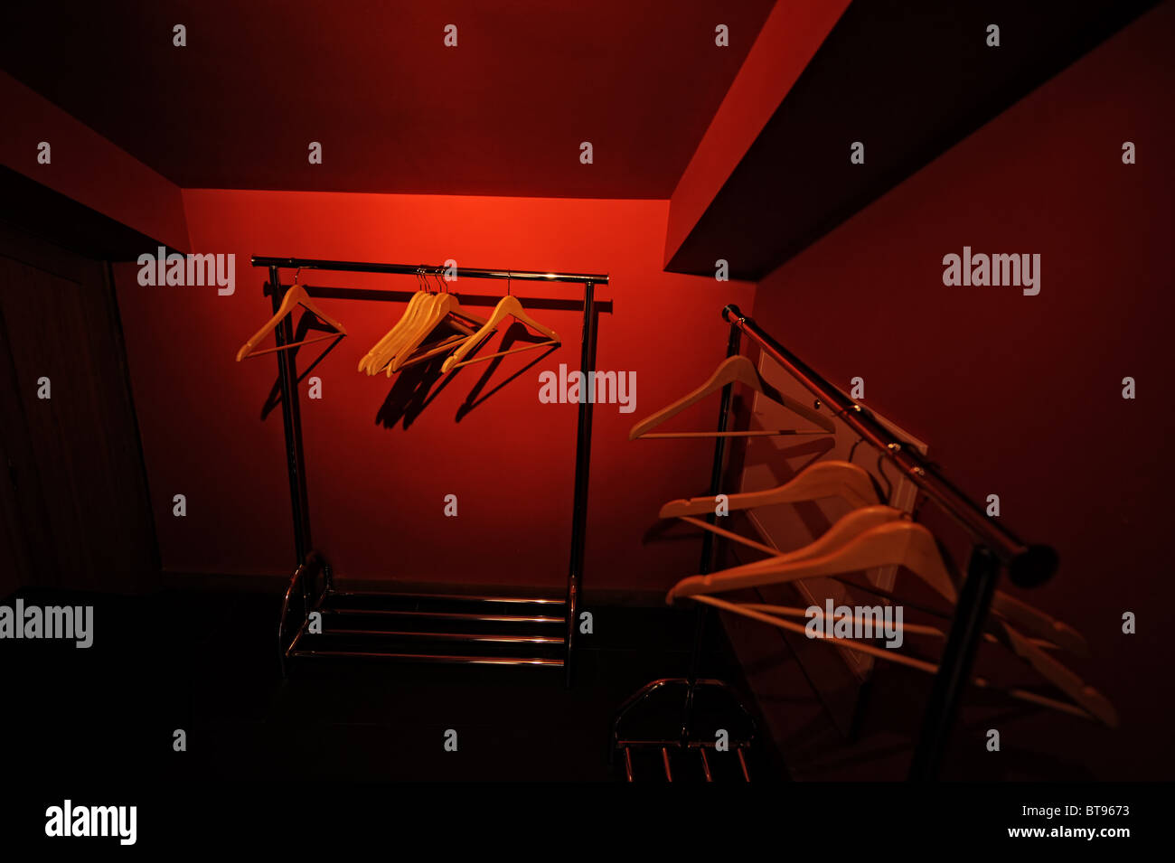Empty walk in closet with hangers and red walls Stock Photo Alamy