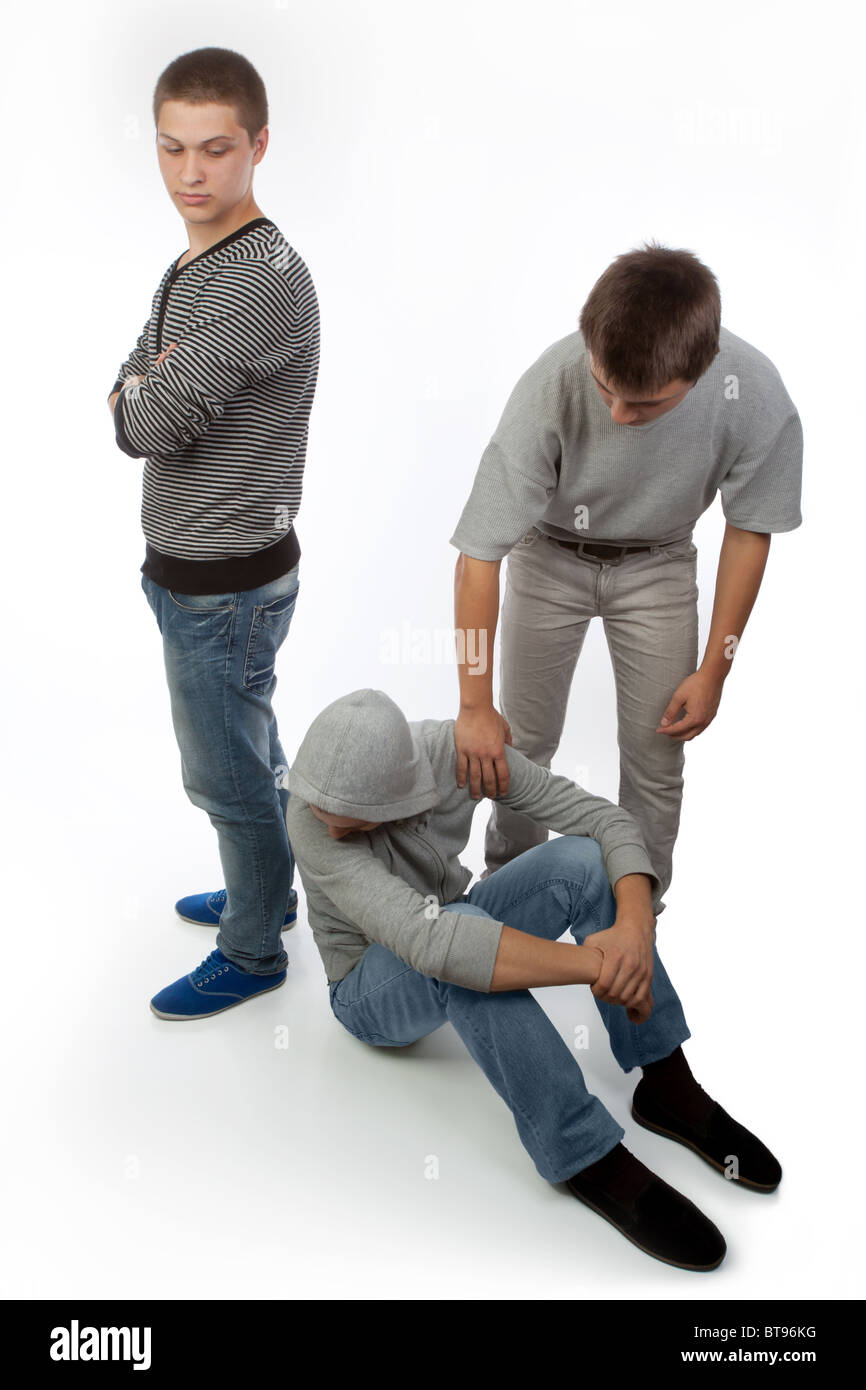 Two upset friends or brothers comforted by a third friend or brother. Stock Photo