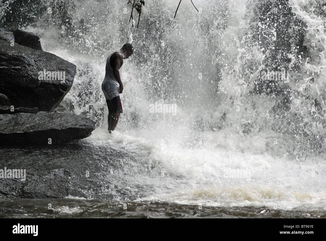 Man bathing in the 'Cascades de Man' waterfall near Man, Ivory Coast
