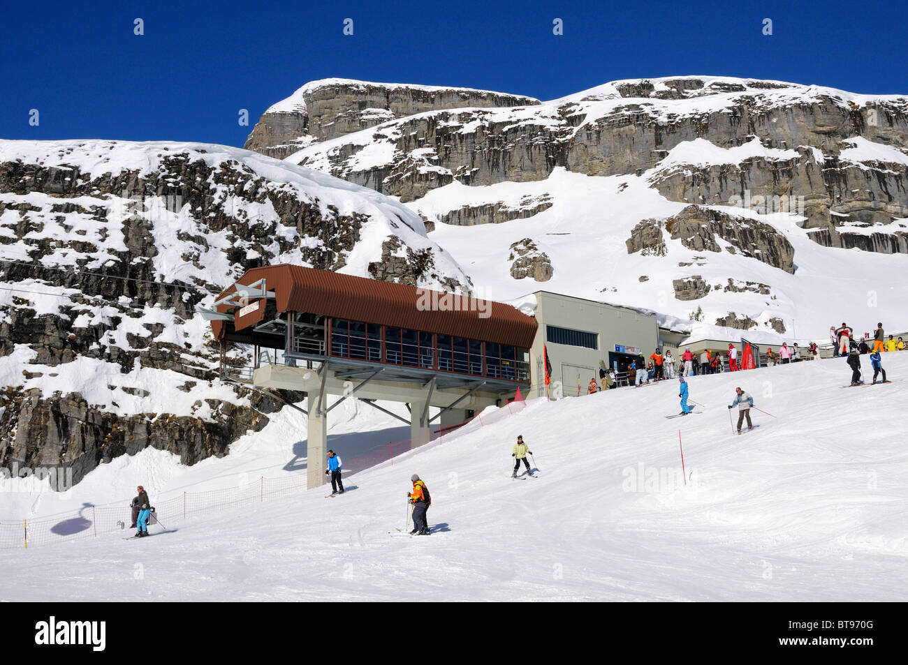 Skiers at the top station of the Les Violettes cable car, Crans Montana, Valais, Switzerland Stock Photo