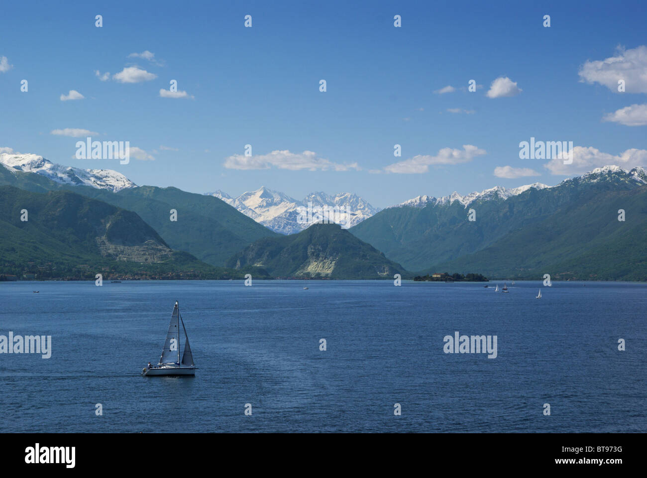 Sail boat in lake Maggiore (northern Italy) in springtime with snowy Alps at the horizon Stock Photo