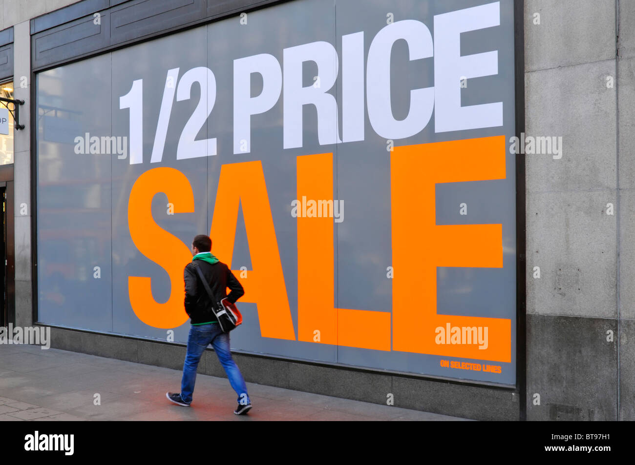 Large shop window poster promoting half price sale (store name digitally removed) Stock Photo