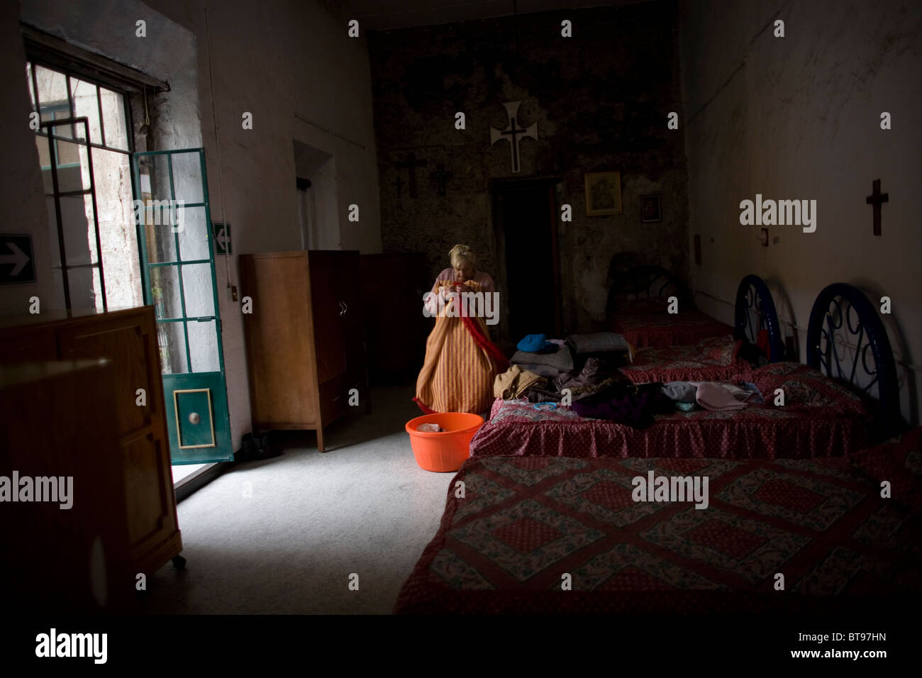 Alma Arjona, 62, folds clothes in the bedrooms at Our Lady of Guadalupe Home for the Elderly, Mexico City, September 25, 2010. Stock Photo