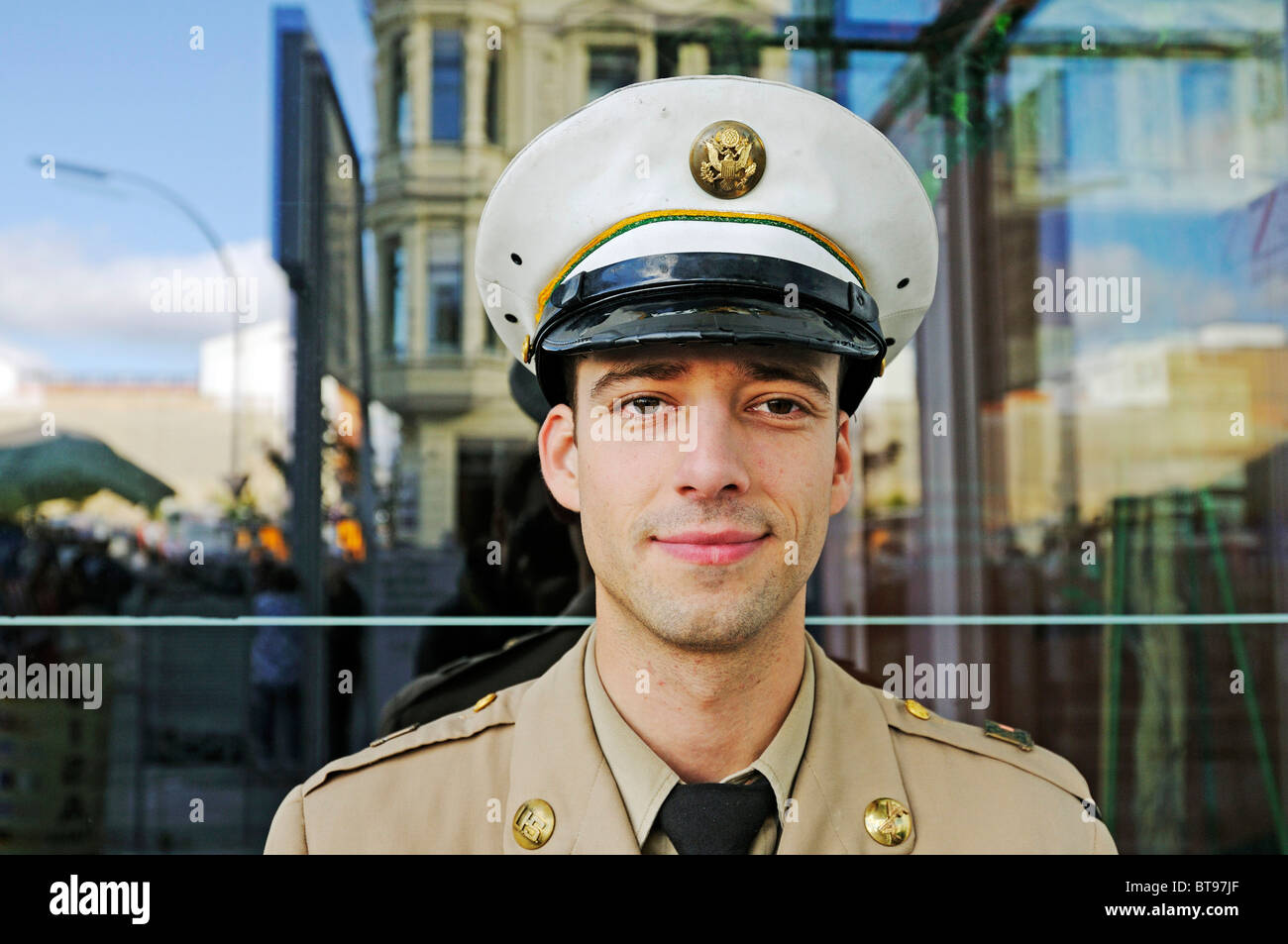 Drama student in the uniform of an American soldier posing for tourists at Checkpoint Charlie, Germany, Europe Stock Photo