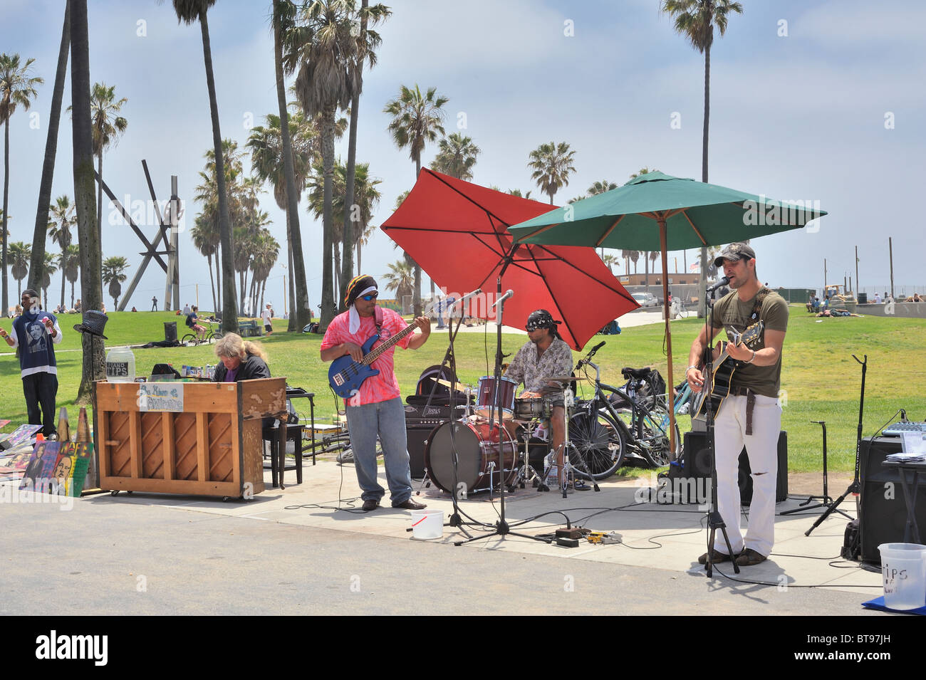 Group of street musicians band playing guitar piano drums singing