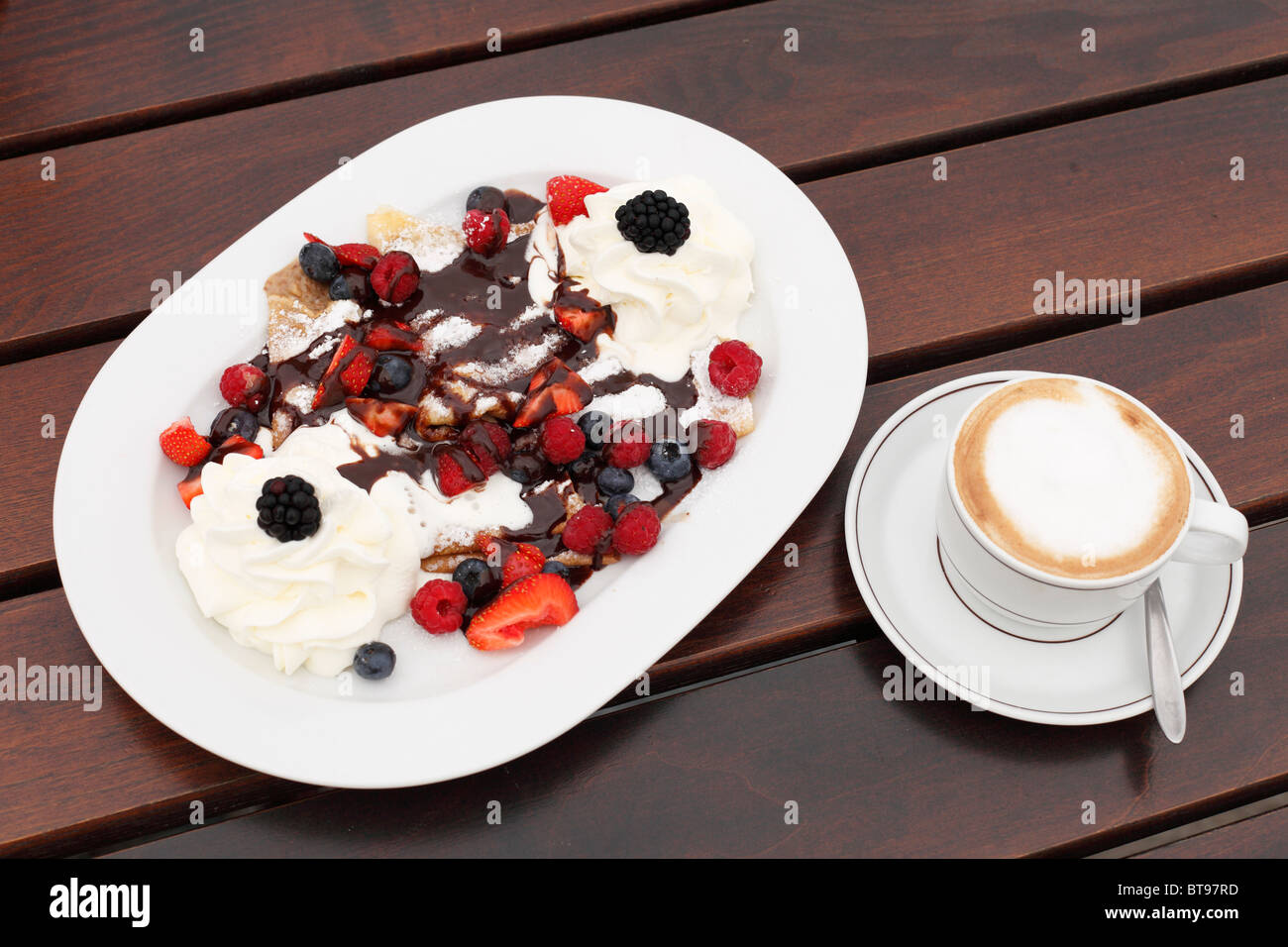 Pancakes with berries and cream, cappuccino, Burgenland, Austria, Europe Stock Photo