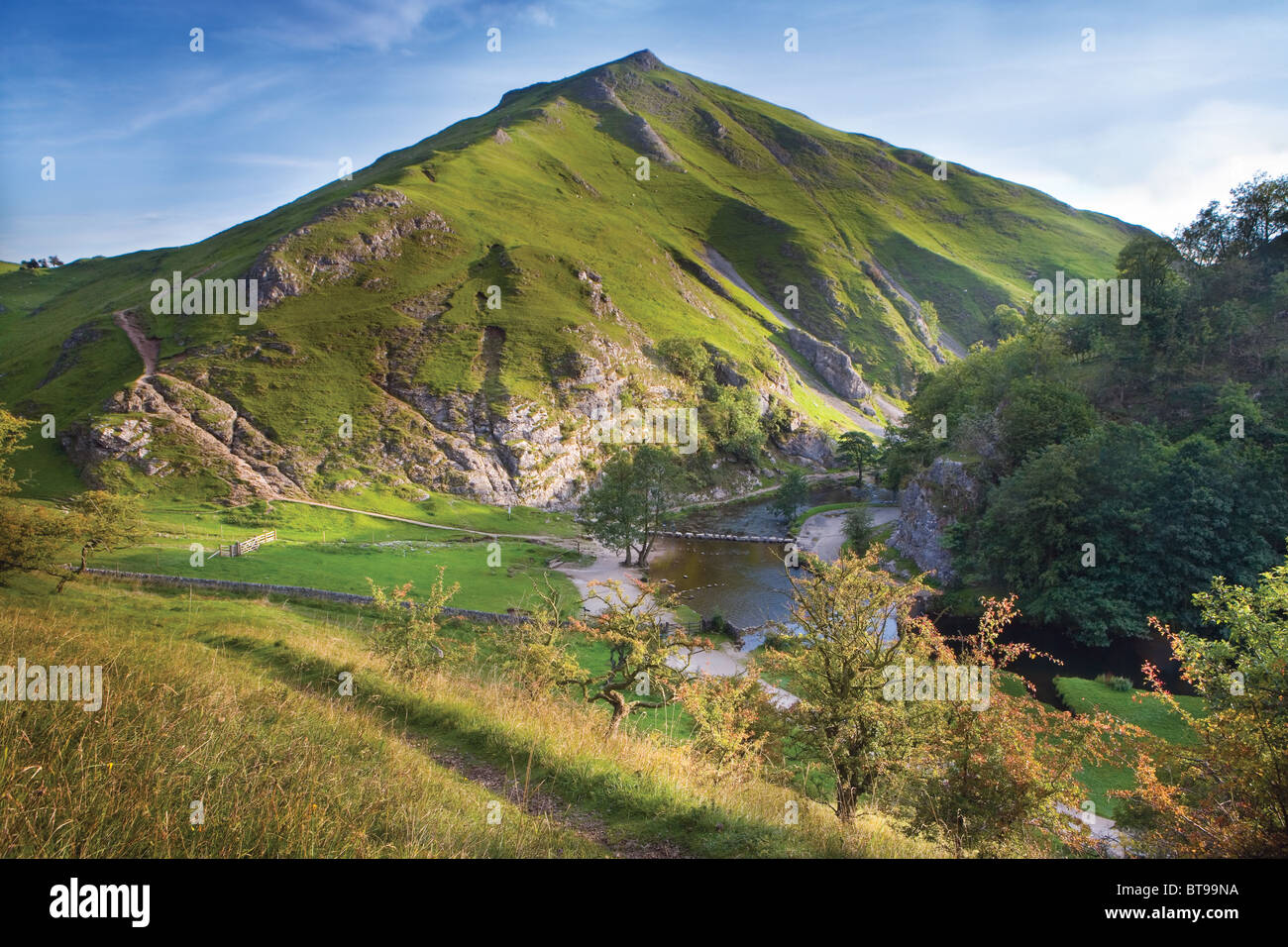 Dovedale with River Dove, stepping stones and the steep-sided Thorpe Cloud, Peak District National Park, Derbyshire, England, UK Stock Photo