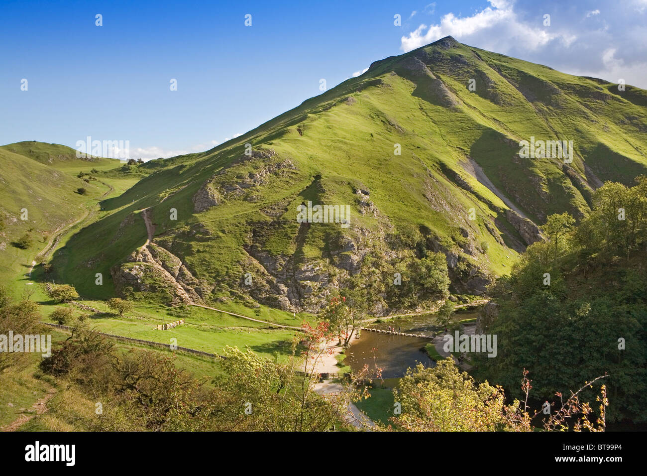 Dovedale with River Dove, stepping stones and the steep-sided Thorpe Cloud, Peak District National Park, Derbyshire, England, UK Stock Photo