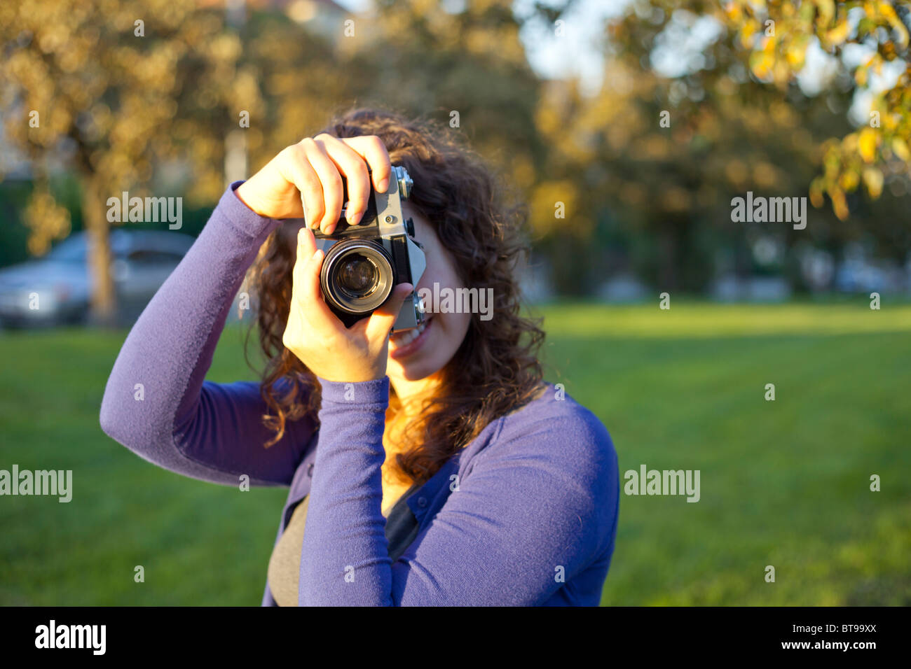 Woman holding vintage camera, portrait Stock Photo