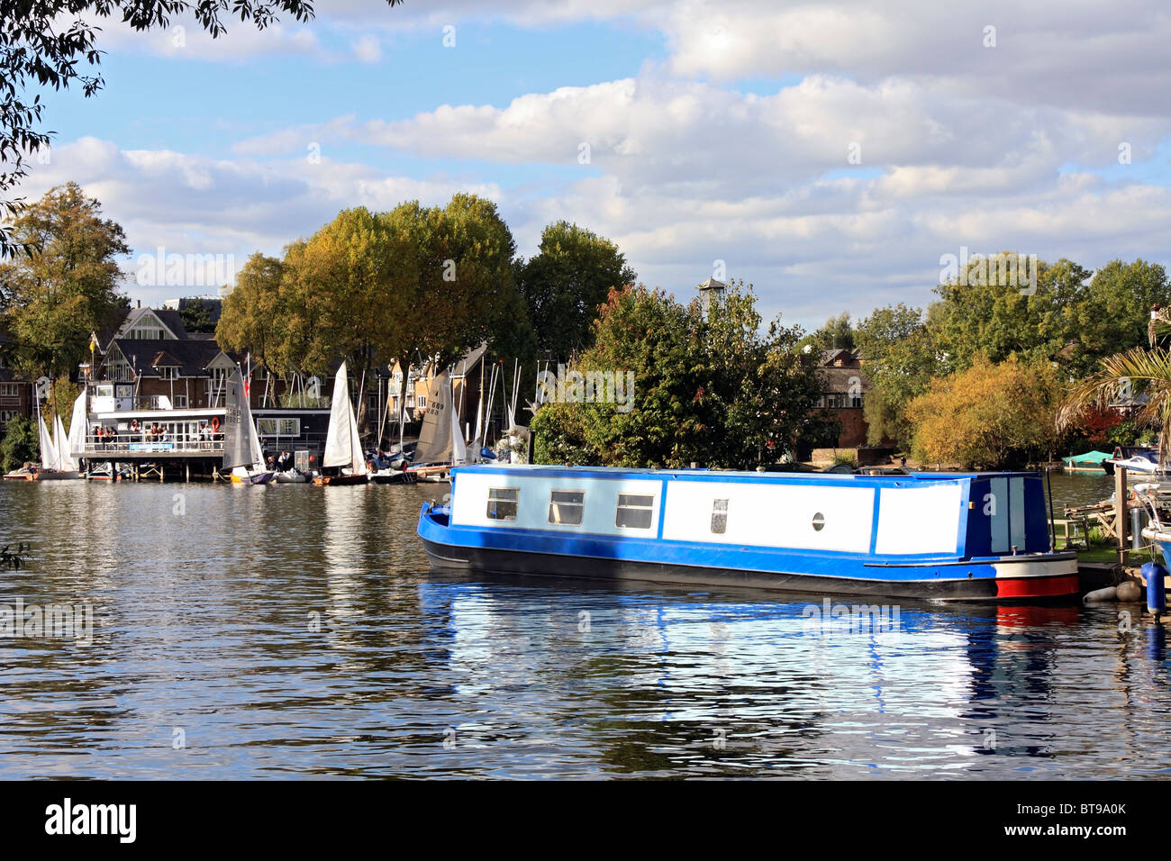Hampton Sailing Club and houseboat on the River Thames at Hampton Stock