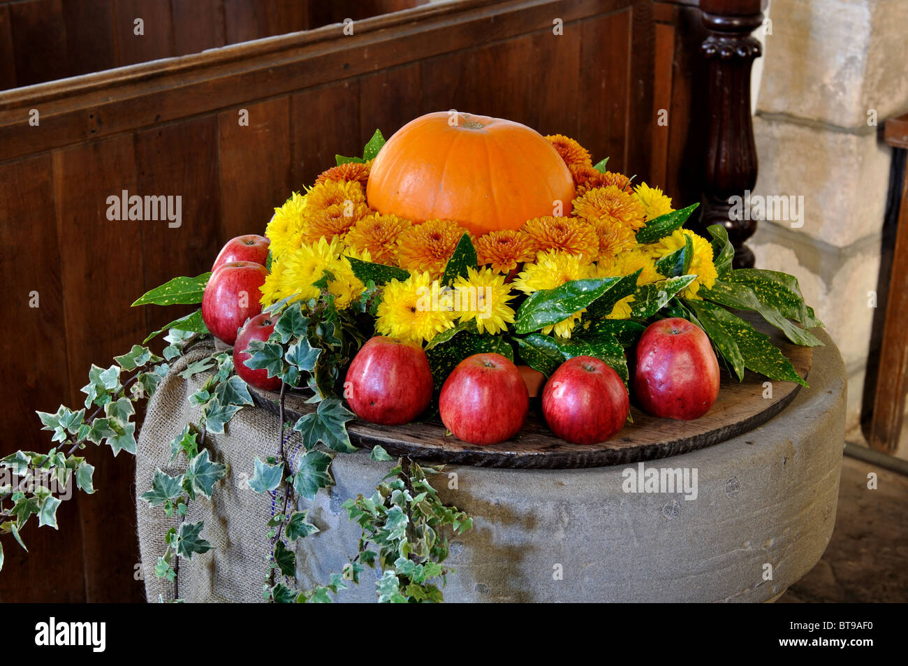 Church font decorated for harvest festival Stock Photo