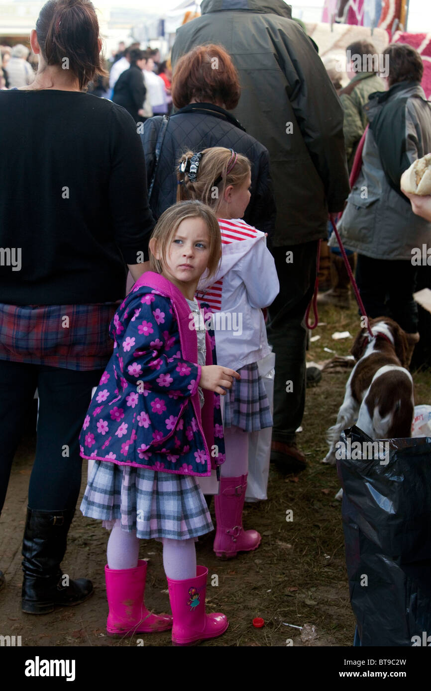 Young gypsy sisters wearing their matching clothes are shopping with their mother at the Stow Horse Fair. DAVID MANSELL Stock Photo