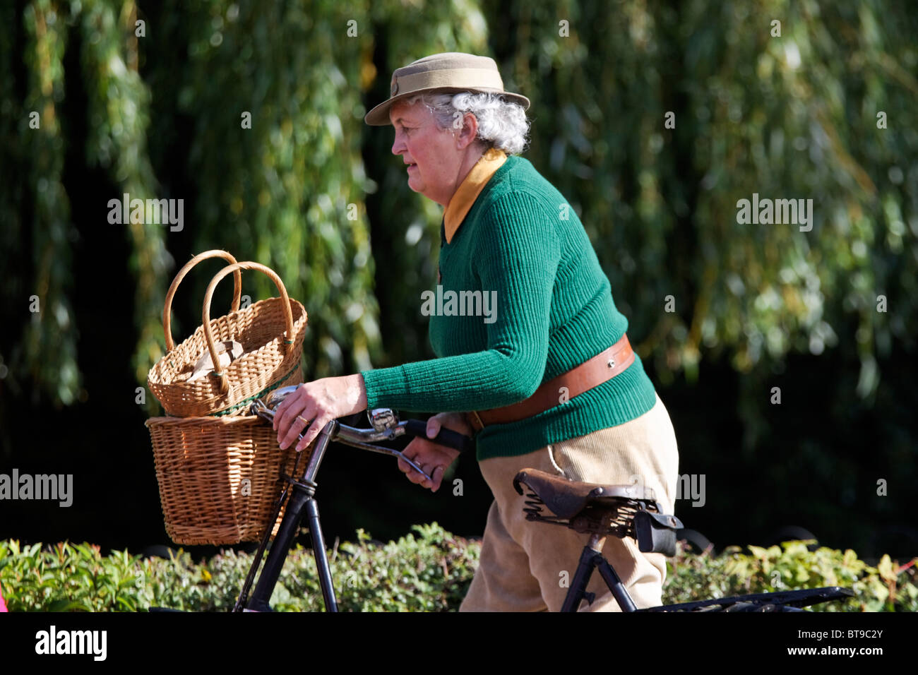 British Women's Land Army Typical Uniform Green Knitted Jumper Brown  Corduroy Trousers & Belt Felt Hat Army Badge 1940s Bike Stock Photo - Alamy