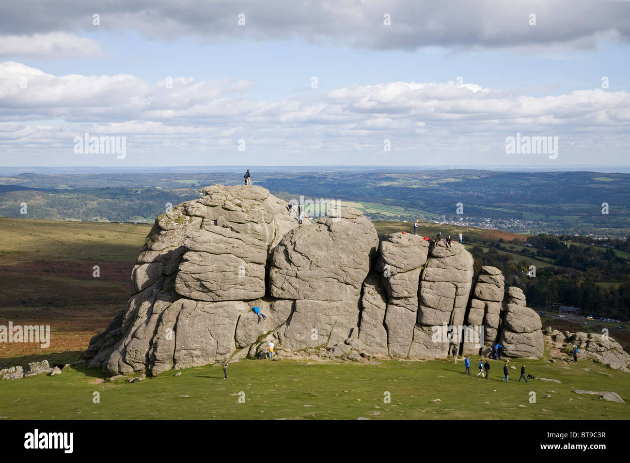 People climb on Haytor rocks Dartmoor National Park Stock Photo