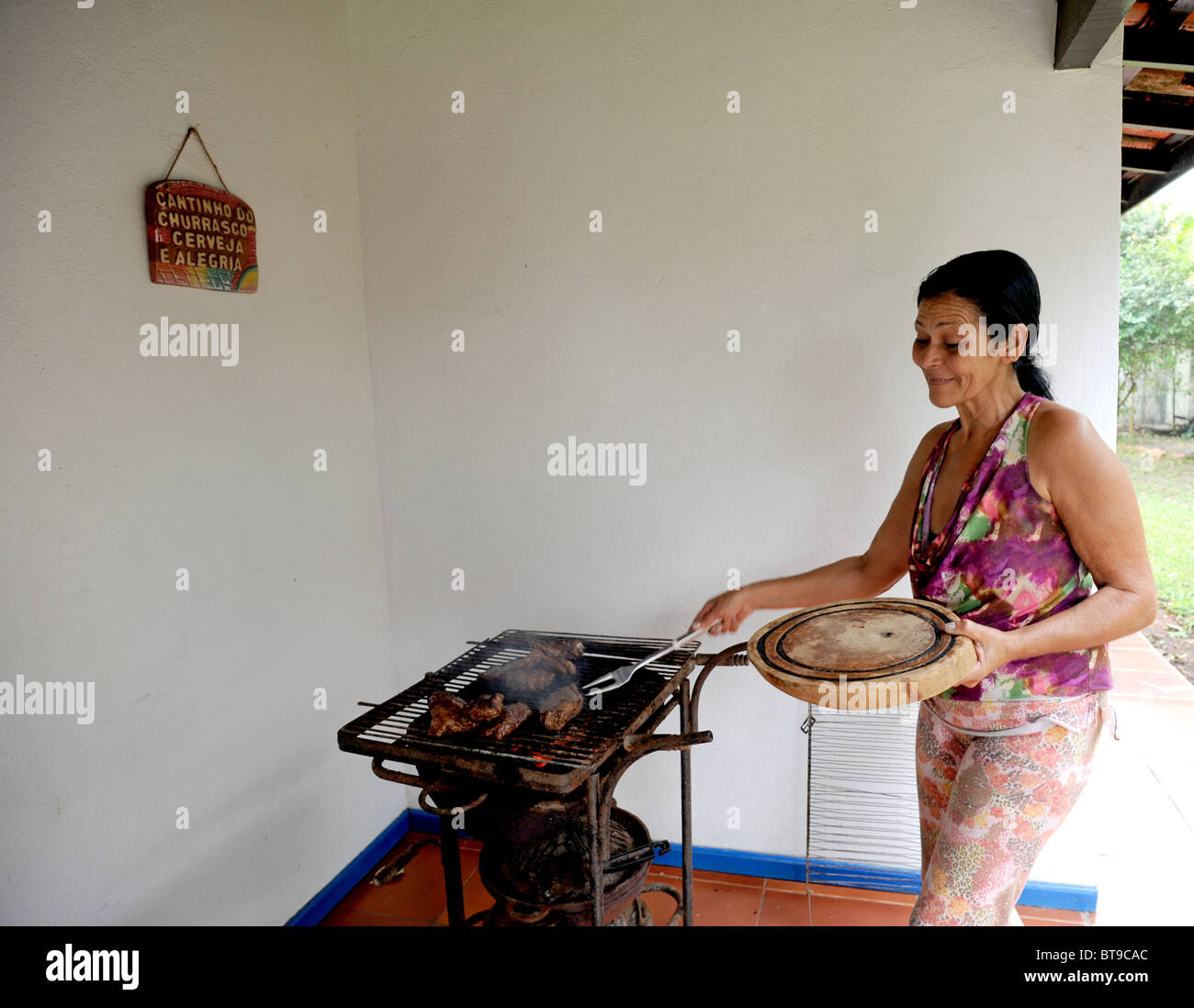 An old Brazilian housekeeper cooks on an outdoor barbecue Stock Photo Alamy