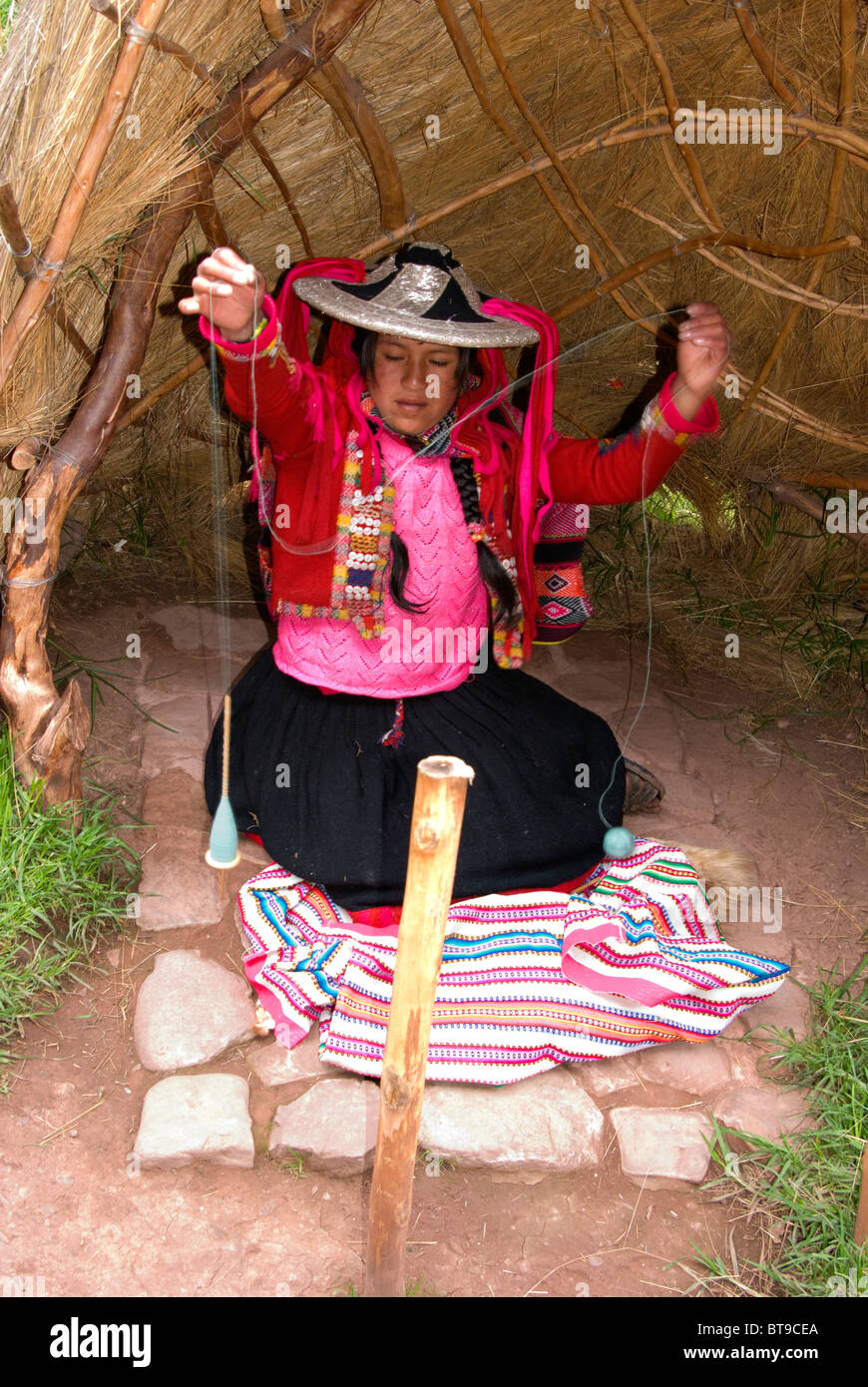Peru, Sacred Valley, nr. Cusco, Awana Kancha, Andean woman carding light blue alpaca wool Stock Photo