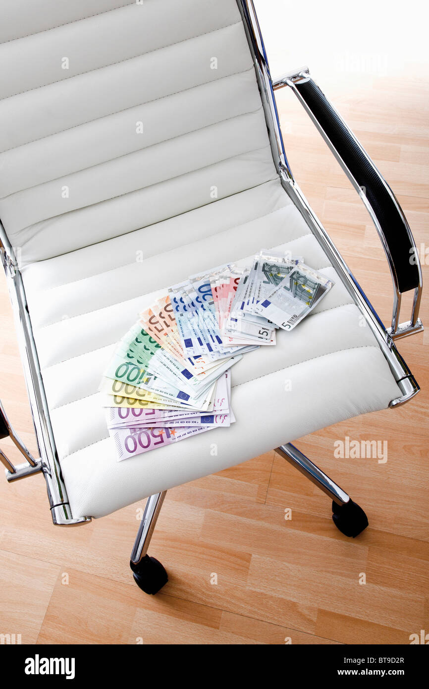 Office chair with euro notes Stock Photo - Alamy