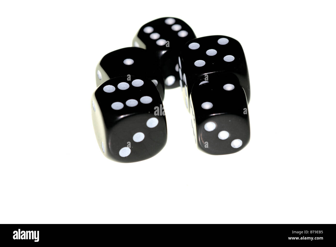 Five black dice randomly arranged on a white background Stock Photo