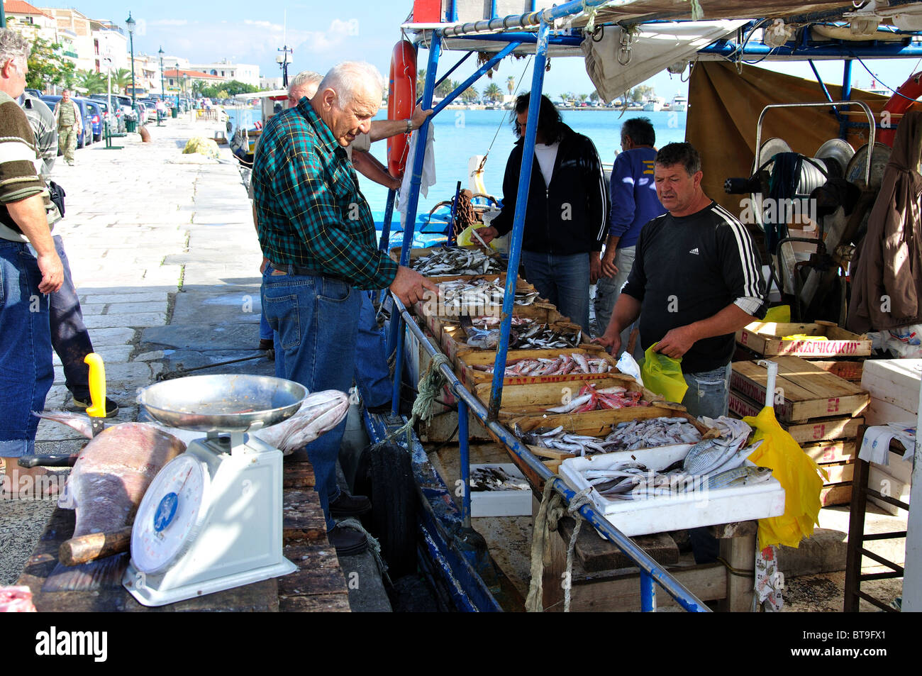 Selling fish off fishing boat on harbour promenade, Zakynthos Town