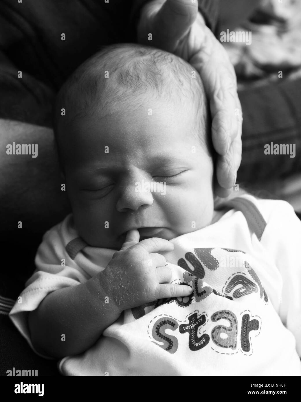 a two week old baby sleeping Stock Photo - Alamy