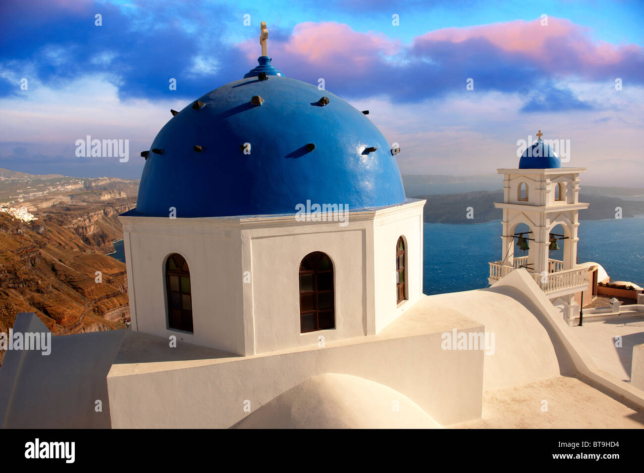 Traditional blue Domed church of Imerovigli looking across the sea, Santorini, Greece. Stock Photo