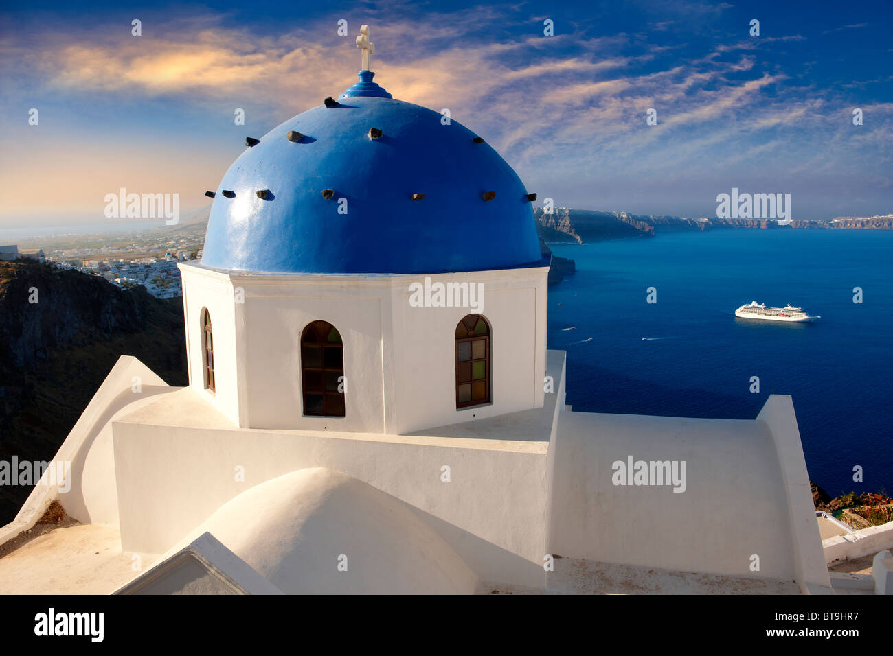 Traditional blue Domed church of Imerovigli looking across the sea, Santorini, Greece. Stock Photo