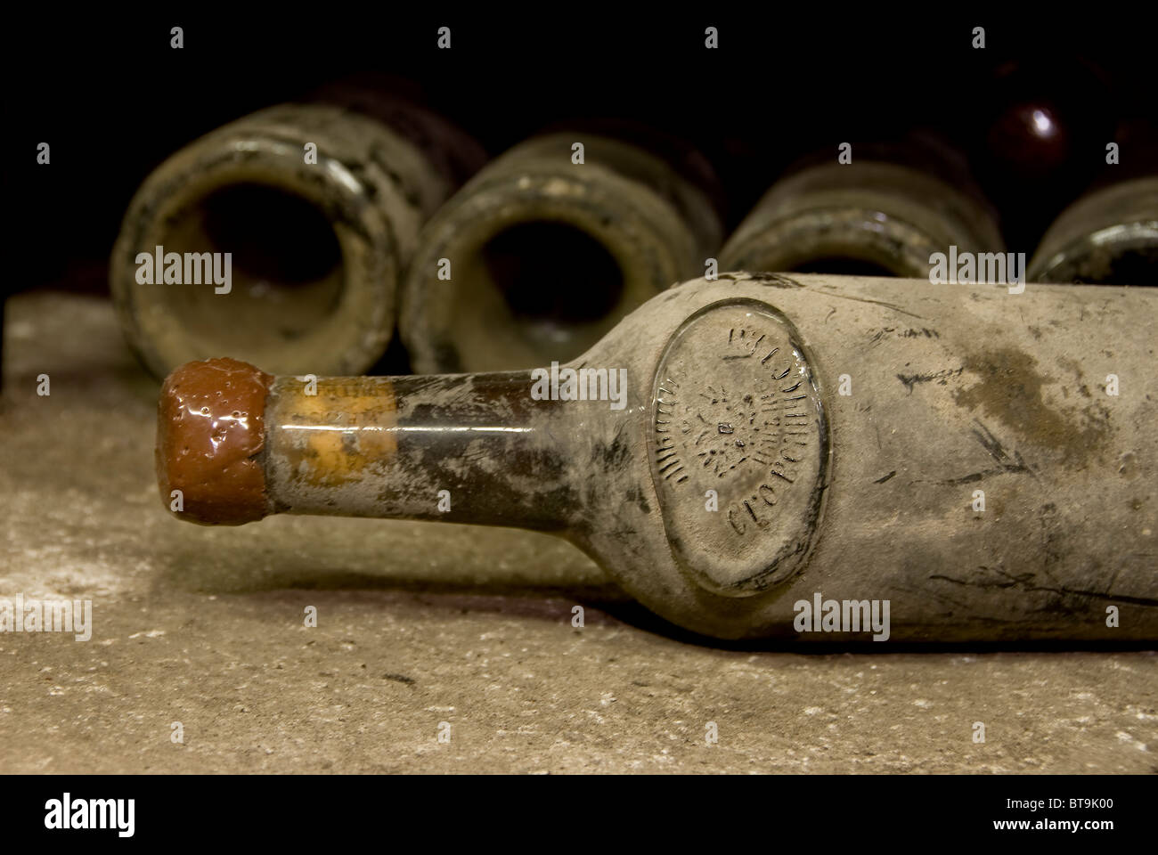 old dirty bottle with other bottles in the background Stock Photo Alamy