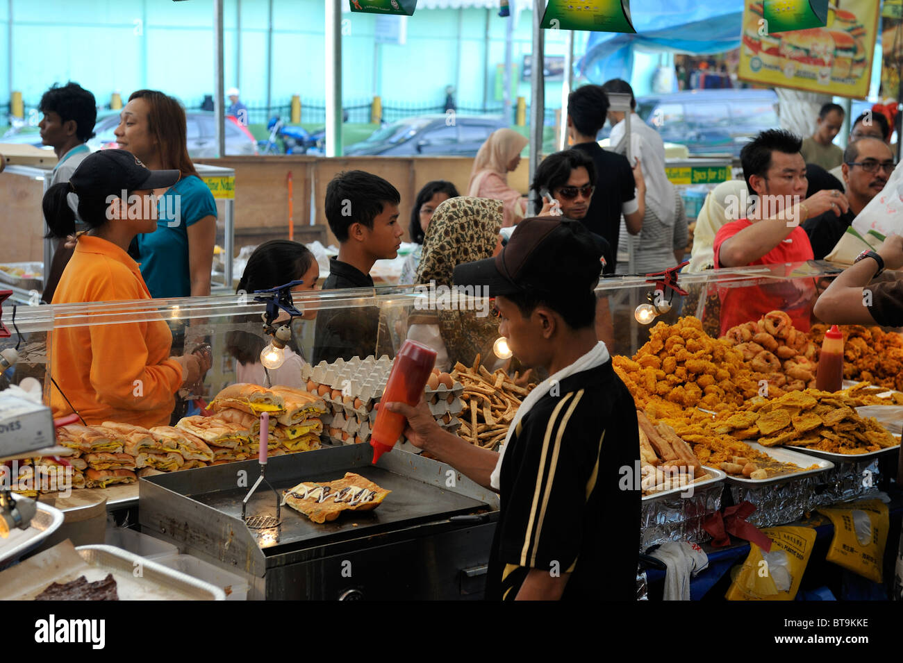 Crowds mass in Katong at Ramadan food stalls, nothing they can eat before dusk. Stock Photo