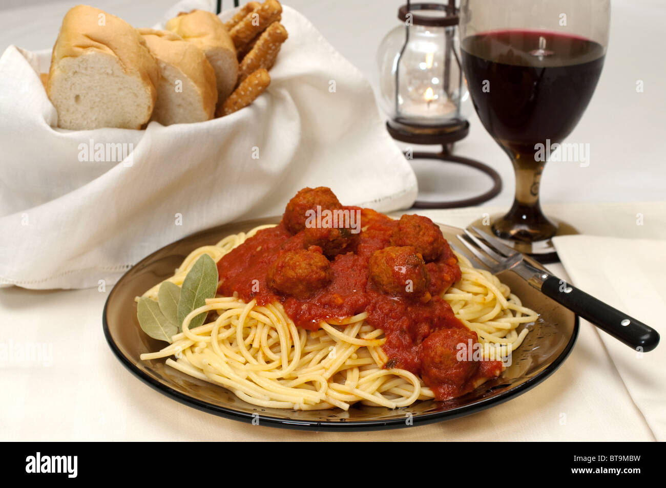 Spaghetti and meatballs dinner with red wine, garlic bread, and bread sticks Stock Photo Alamy