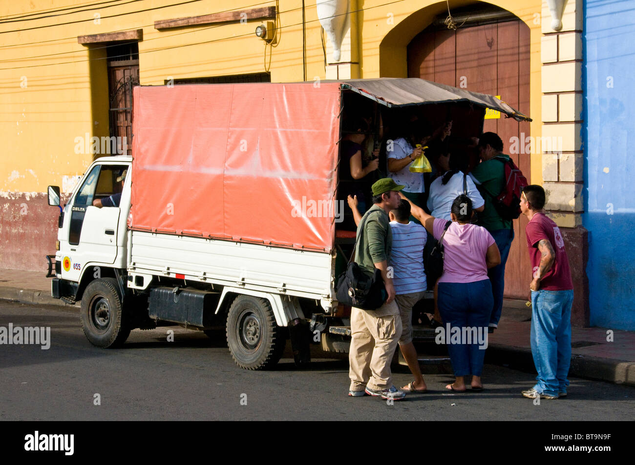 People in a truck used as public transportation Nicaragua city of Leon Stock Photo