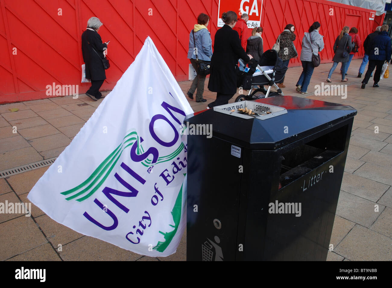 After the rally a Unison flag is abandoned in a litter bin on Princes Street, Edinburgh. Stock Photo