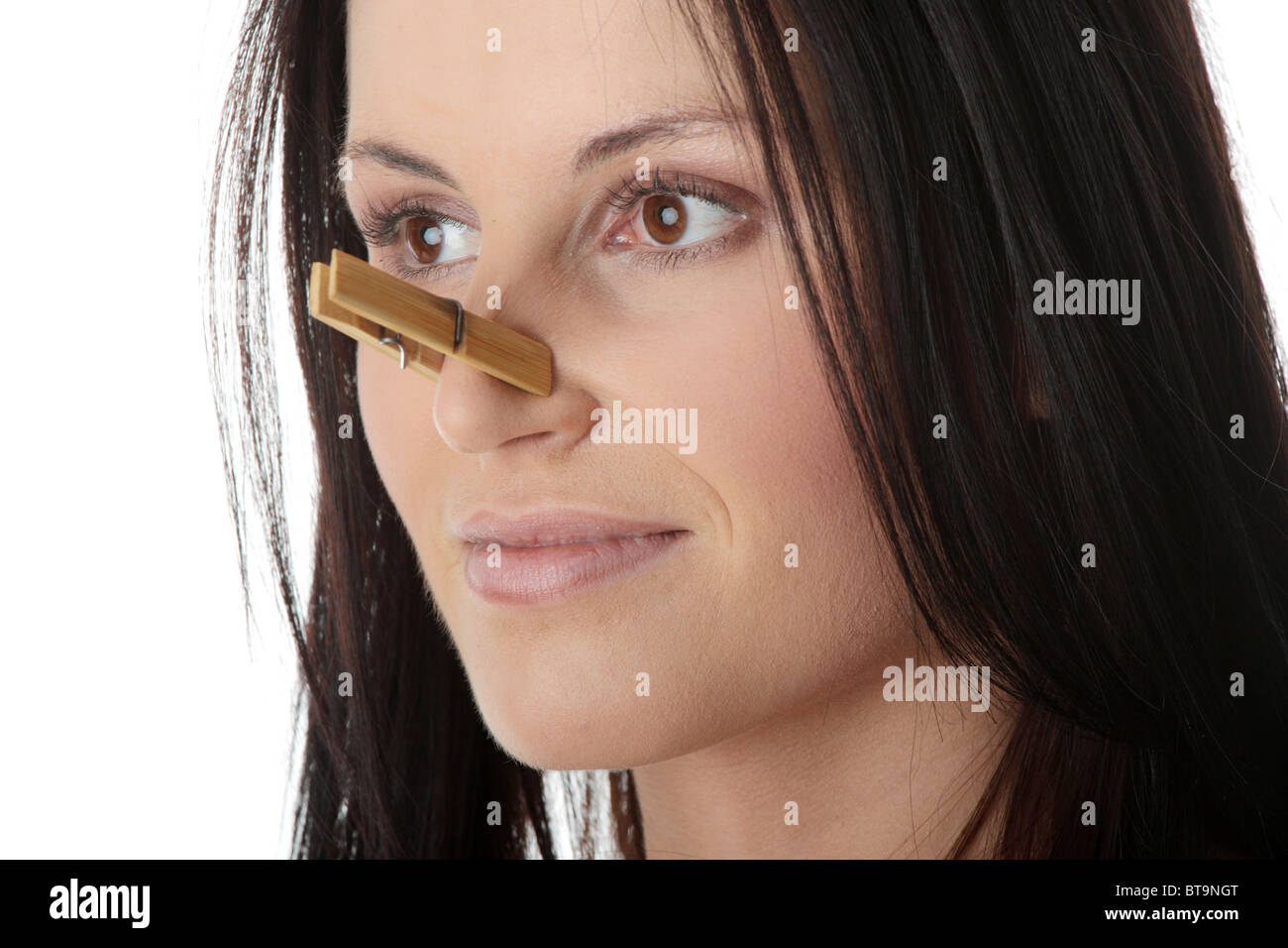Portrait of young caucasian woman with Clothespin on her nose bad smell concept Stock Photo